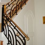 Wrought wrought iron interior railing with brass handrail