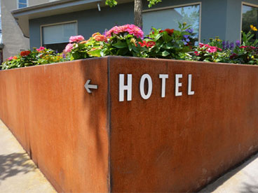 Corten steel wall with "Hotel" lettering