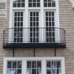Exterior iron balcony railing accenting beautiful windows Exterior iron balcony railing window view