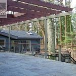 Exterior patio railings with cables and painted posts Exterior patio railings with cables and painted posts