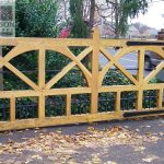 Wrought iron gate partitions and hinges built into a large wooden frame wrought iron gate partitions and hinges built into a large wooden frame