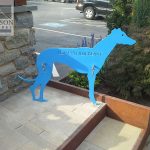 Steel painted dog silhouette sign saying "leash your beast" Steel painted dog silhouette sign saying "leash your beast"