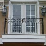 French doors open to an exterior iron balcony railing French doors open to an exterior wrought iron balcony railing
