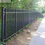 Custom fence near a walkway Custom wrought iron fence near a walkway