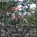 Wrought iron gate with various metal ornaments Wrought iron gate with various metal ornaments