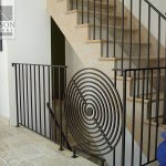 Circular spiral pattern interior gate and railing Circular spiral pattern interior wrought iron railing with gate