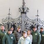 Employee group photo in front of completed Princeton University 1911 front gate restoration.